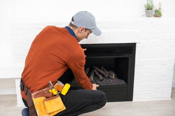 Man cleaning fireplace from ashes
